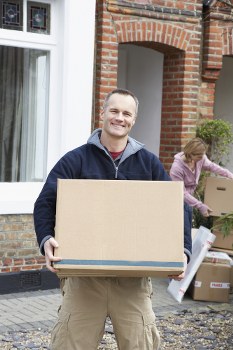 Professional movers carefully packing household items