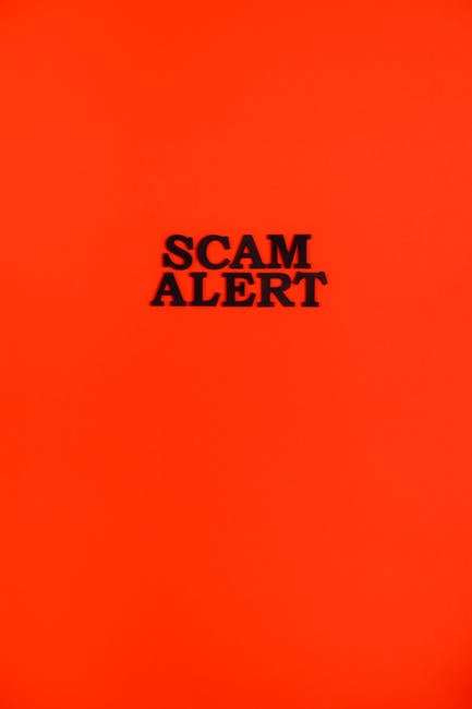 A bright orange background displaying the bold black text 'SCAM ALERT' in the center, designed to catch attention and warn of potential fraudulent schemes. The simple, high-contrast design emphasizes 